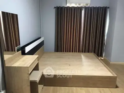 Spacious minimalist bedroom with wooden platform bed and vanity