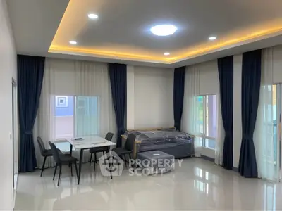 Spacious modern living room with elegant dining area and stylish lighting