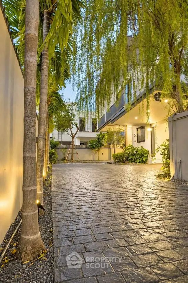 Charming modern home exterior with lush garden and elegant lighting