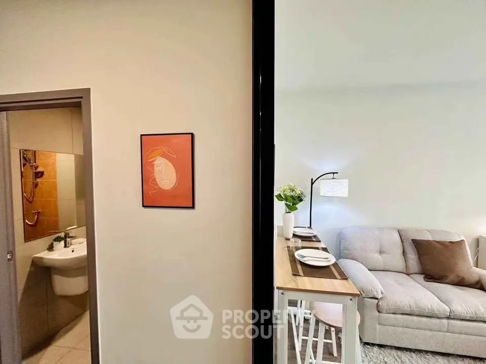 Modern apartment interior with cozy living room and adjacent bathroom, featuring stylish decor and functional layout.