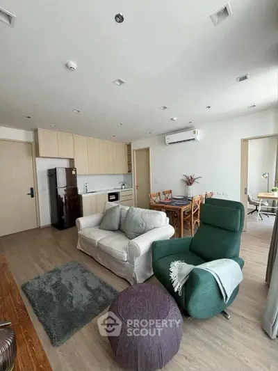 Spacious modern living room with open kitchen and stylish furniture in a contemporary apartment.