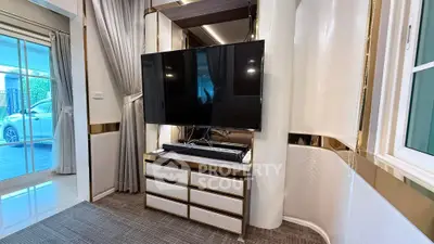 Luxurious living room with modern TV setup and elegant decor