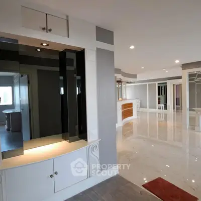 Luxurious open-plan living space with elegant marble flooring and modern design.