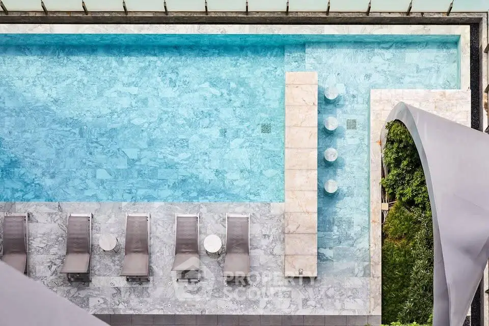 Luxurious rooftop pool with sun loungers and modern design