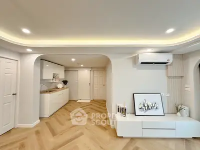 Modern living room with elegant decor and open kitchen layout