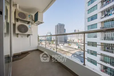 Spacious balcony with city view in modern high-rise building
