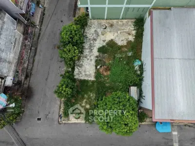 Aerial view of a vacant urban lot surrounded by buildings, ideal for development opportunities.