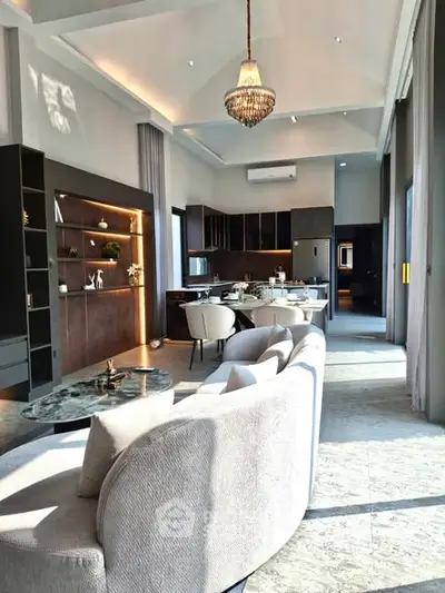 Luxurious open-plan living room with elegant decor and high ceilings