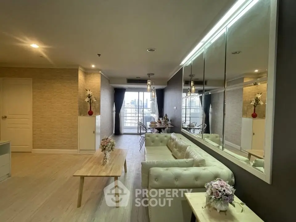 Spacious living room with elegant decor and city view balcony in modern apartment.