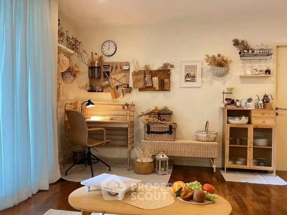Charming living room with cozy decor and natural light, featuring a stylish workspace and wooden furniture.