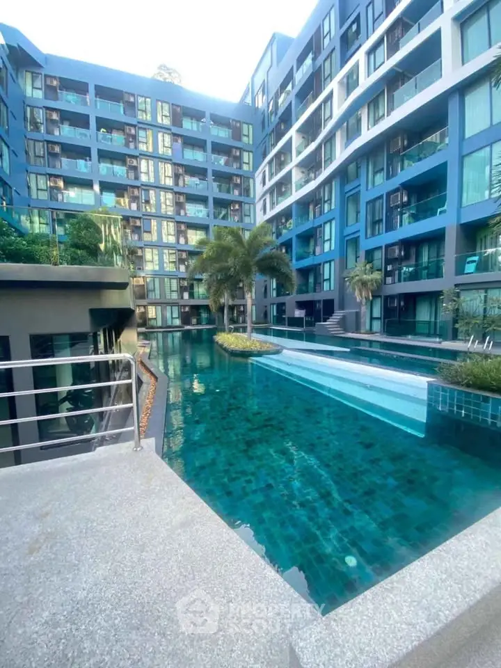 Modern condominium with stunning pool and lush greenery