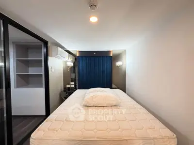 Modern bedroom with sleek design and built-in storage, featuring a comfortable mattress and ambient lighting.