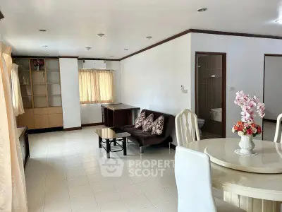 Spacious living room with dining area and natural light in modern apartment