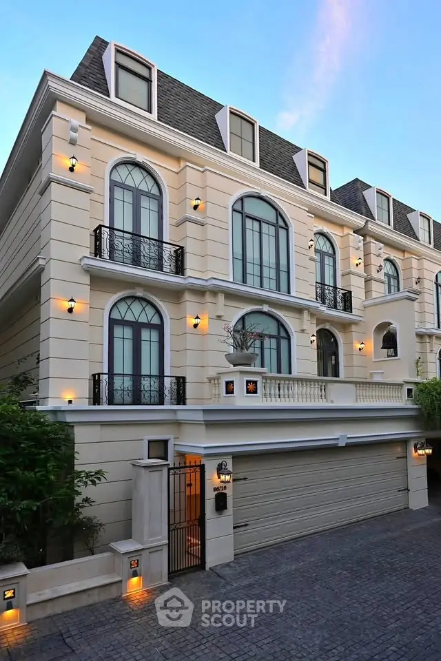 Elegant three-story townhouse with classic architecture and modern lighting.