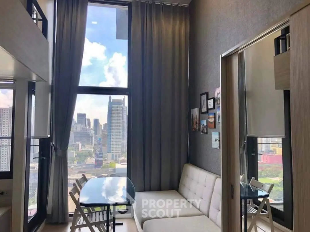 Modern living room with city view, high ceilings, and stylish decor in urban apartment.