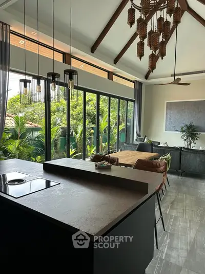 Luxurious open-plan living room with high ceilings and lush garden view, perfect for modern living.