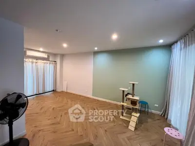 Spacious living room with elegant parquet flooring and ambient lighting