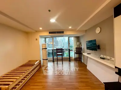 Spacious living room with city view and modern furnishings in high-rise apartment