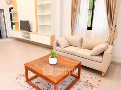 Charming living room with cozy sofa, wooden coffee table, and built-in TV unit.