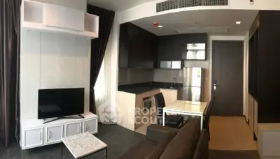 Modern open-layout living room with kitchen, featuring sleek furniture and contemporary design.