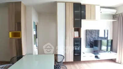 Modern living room with stylish furniture and wall-mounted TV