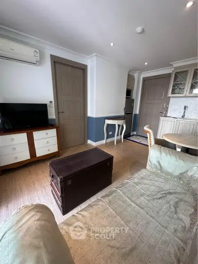 Charming living room with cozy decor and modern amenities in a stylish apartment.