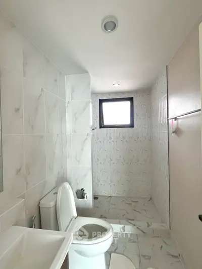 Modern bathroom with elegant marble tiles and natural light