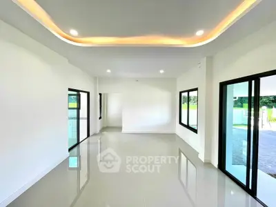 Spacious modern living room with sleek lighting and large windows