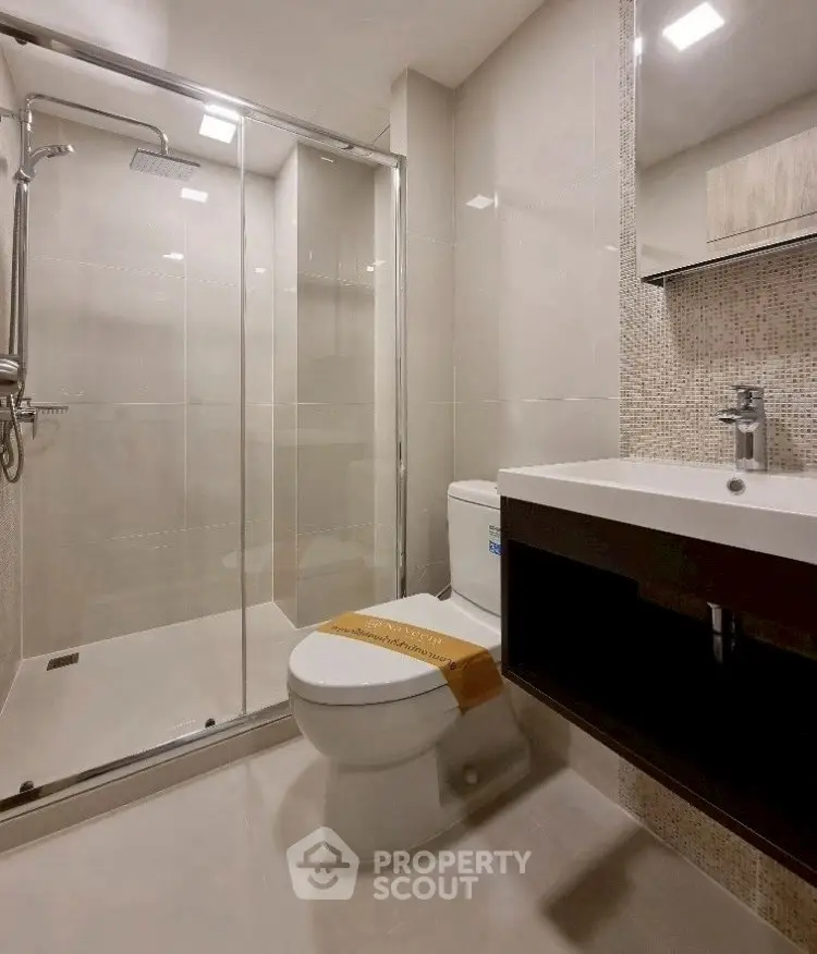 Modern bathroom with glass shower and sleek fixtures