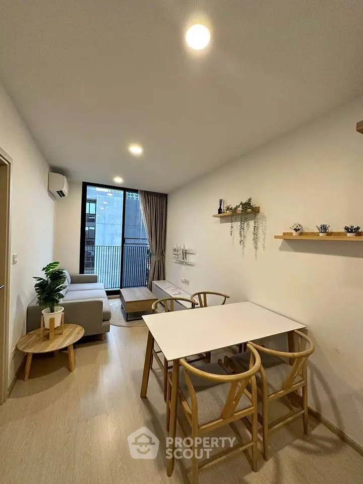 Modern living room with stylish dining area and balcony view
