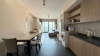 Modern open-plan kitchen and living room with sleek design and natural light.