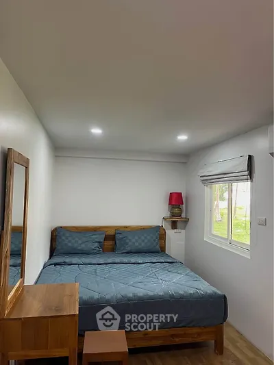 Cozy bedroom with wooden furniture and natural light