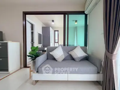 Modern living room with stylish sofa and natural light, perfect for relaxation and comfort.