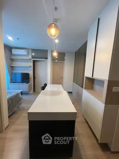 Modern kitchen with sleek design and stylish lighting in a contemporary apartment.