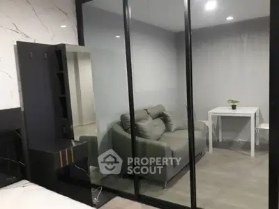 Modern living room with glass partition and stylish furniture
