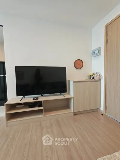 Modern living room with sleek TV stand and wooden flooring, perfect for cozy entertainment nights.