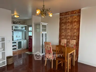 Charming dining area with vintage chandelier and cozy kitchen view