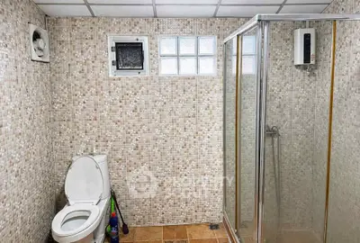 Modern bathroom with tiled walls and glass shower enclosure