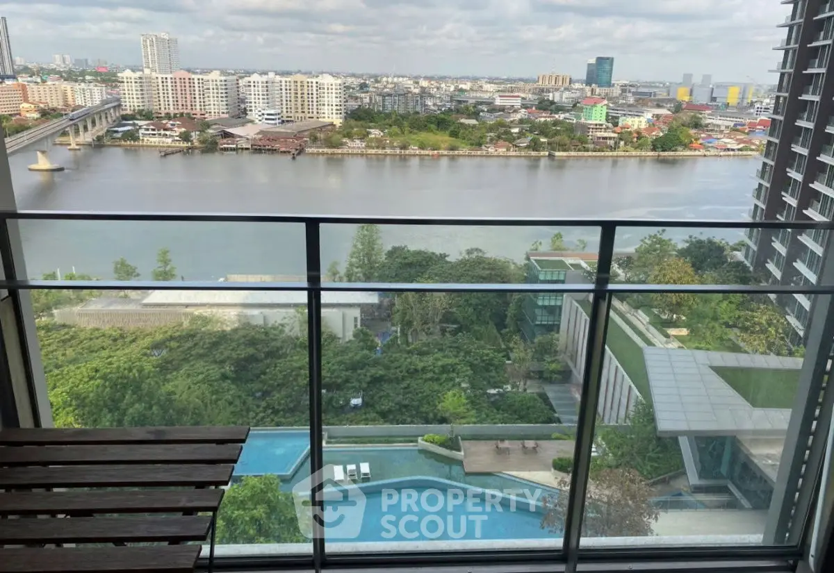 Stunning river view from high-rise balcony with pool and cityscape