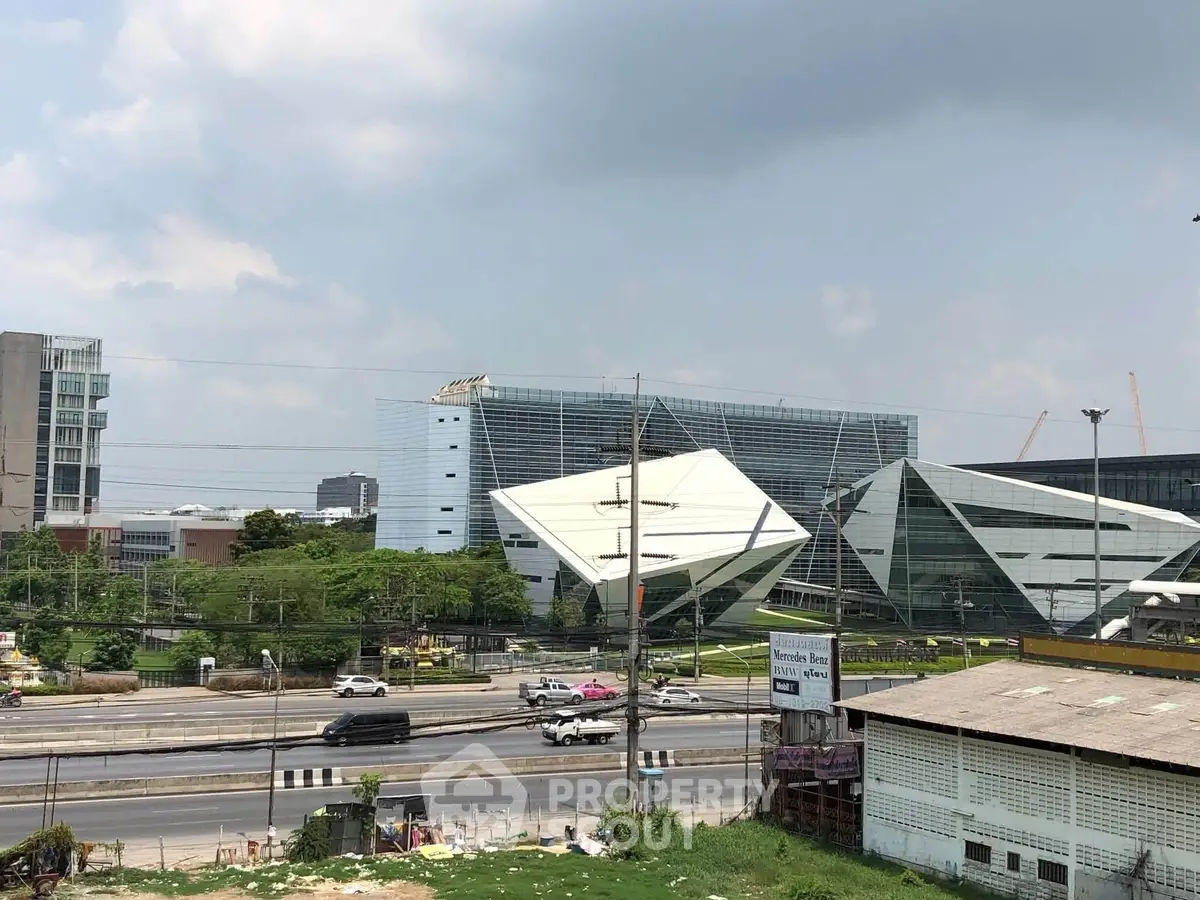 Modern architectural buildings with unique geometric designs and lush greenery in urban setting.
