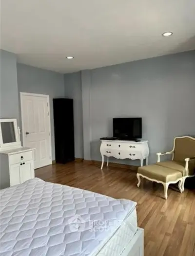 Elegant bedroom with classic furniture and hardwood flooring