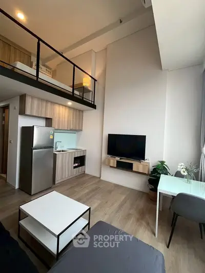 Modern loft apartment with high ceilings, open living area, and stylish kitchen.