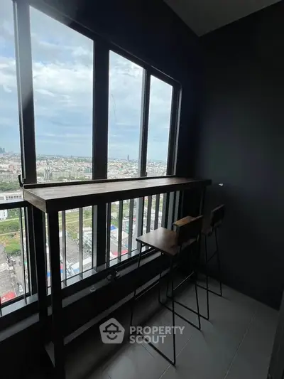 Modern high-rise balcony with stunning city view and sleek bar seating.