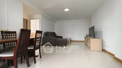 Spacious living room with modern furniture and dining area in open layout.