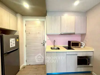 Modern kitchen with sleek cabinets and appliances in a compact layout