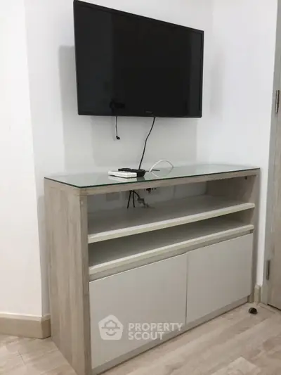 Modern living room with wall-mounted TV and sleek storage unit