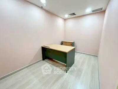 Minimalist office space with wooden desk and cabinet, ideal for productivity.