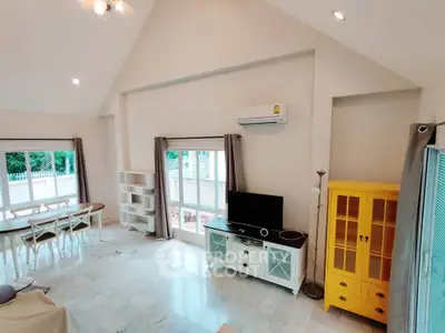 Spacious living room with modern decor and large windows for natural light