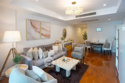 Spacious and elegantly furnished living room with modern decor and wooden flooring.