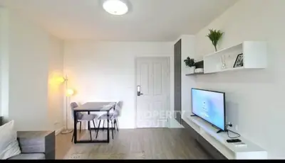 Modern living room with sleek furniture and wall-mounted TV